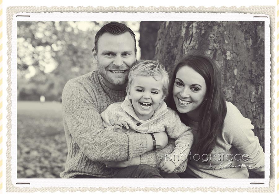 family photography london: parents hugging 3 year old boy during a photoshoot outdoor