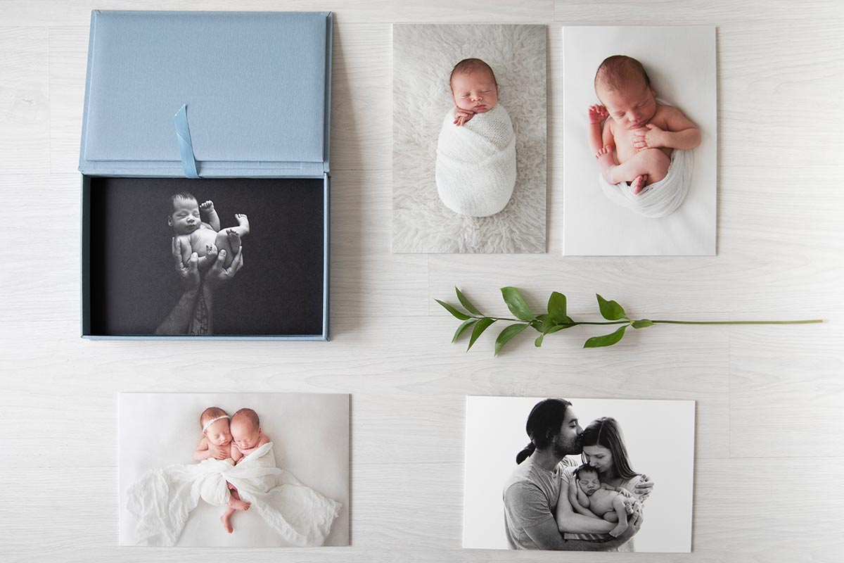 blue box with fine art prints of newborn babies