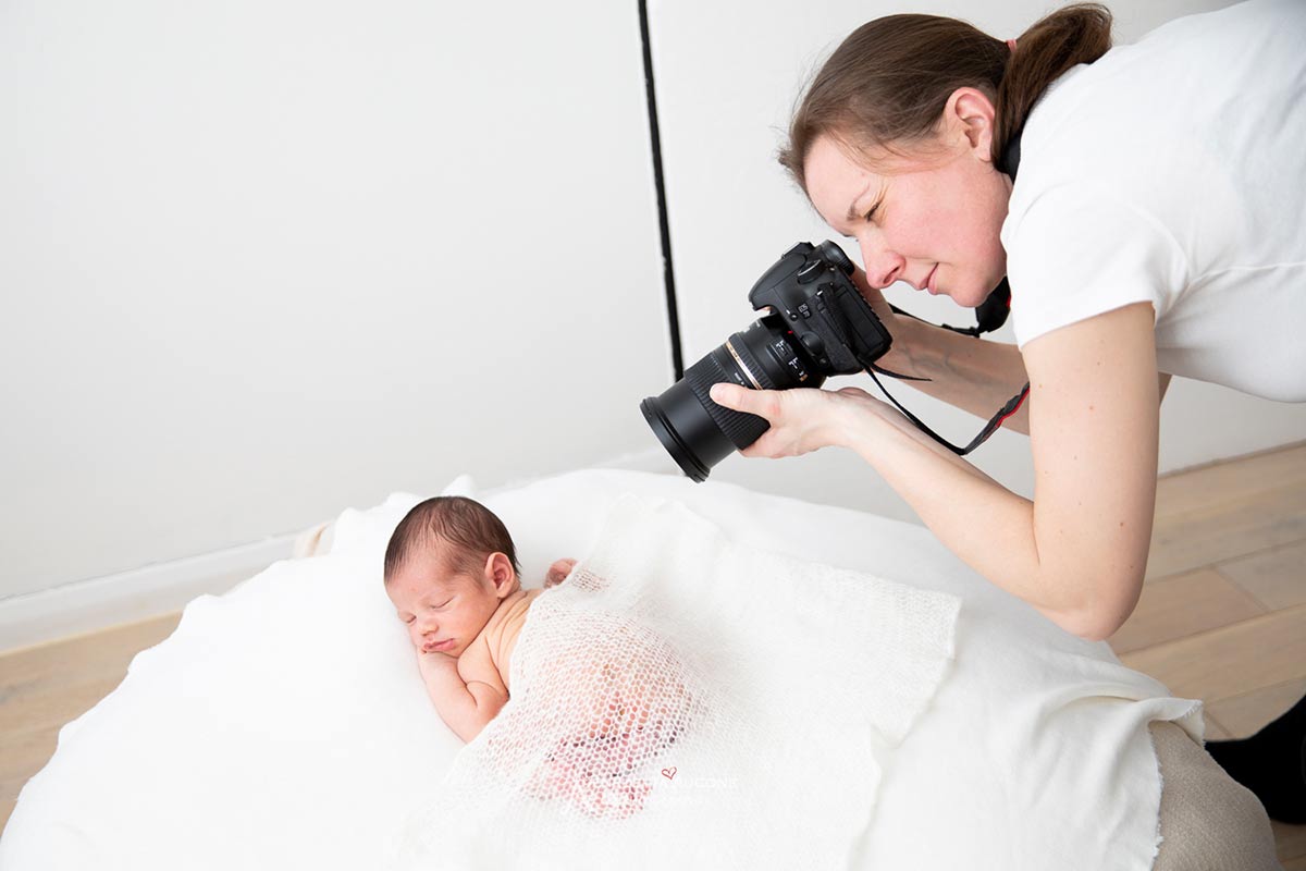behing the scene showing Valentina, a London newborn photographer, photographing a little newborn baby